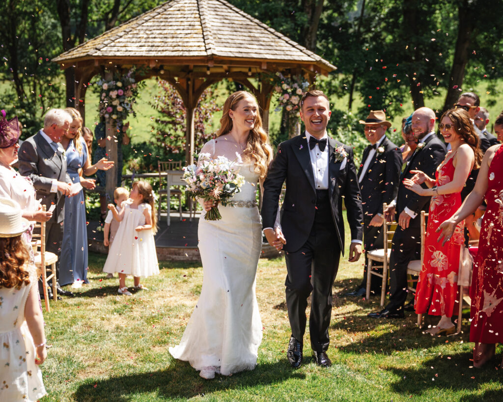 Bride and groom walking at outdoor wedding ceremony