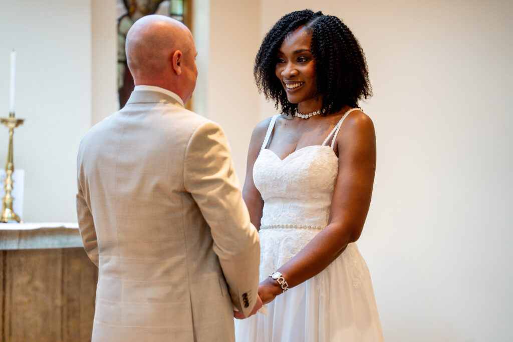 Bride and groom holding hands during ceremony